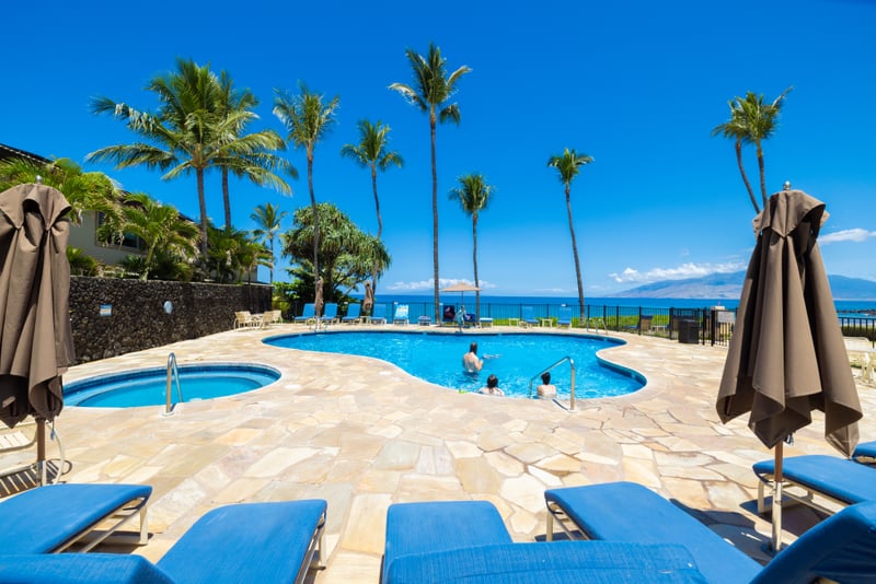 Tranquil infinity-style pool, tropical landscaping, ocean views & private gated beach access steps away