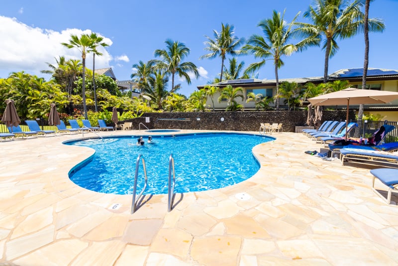 Oceanfront pool deck with luxury loungers, lush gardens & direct access to pristine white sand beaches