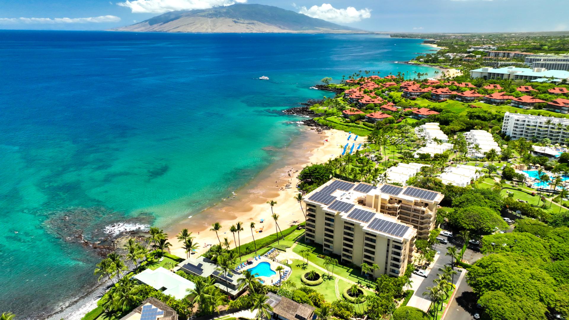 Oceanfront resort residence featuring direct beach access, poolside relaxation & elegant island serenity