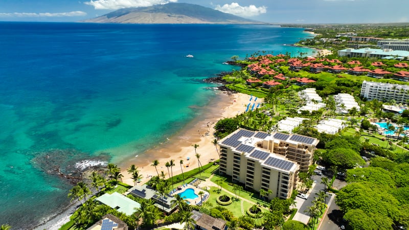 Oceanfront resort residence featuring direct beach access, poolside relaxation & elegant island serenity