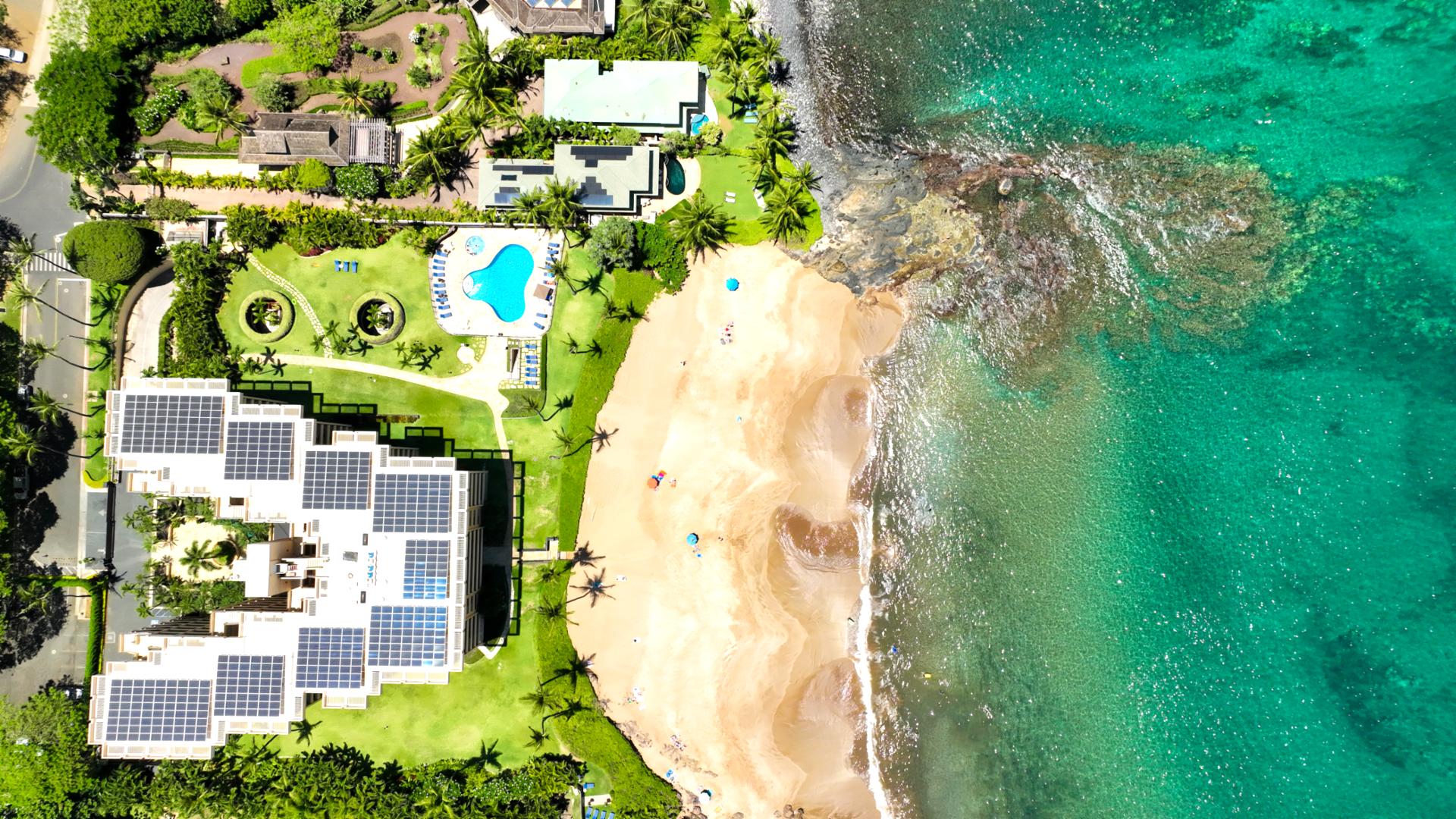 Exclusive oceanfront retreat with private beach, resort pool, tropical gardens & eco-luxury solar design