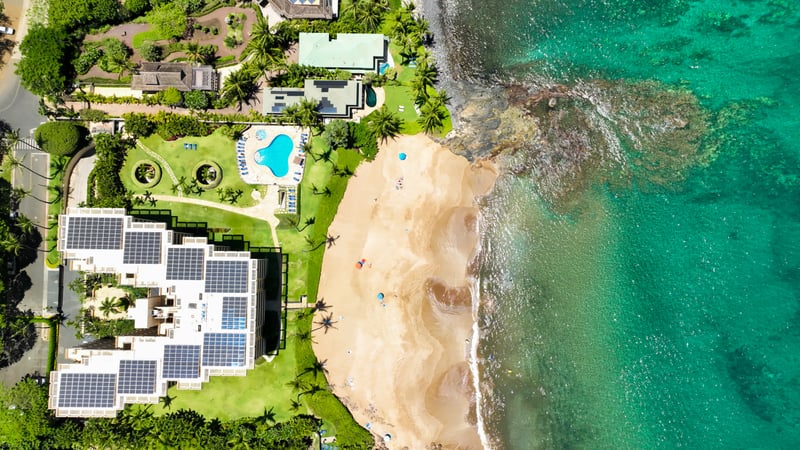 Exclusive oceanfront retreat with private beach, resort pool, tropical gardens & eco-luxury solar design