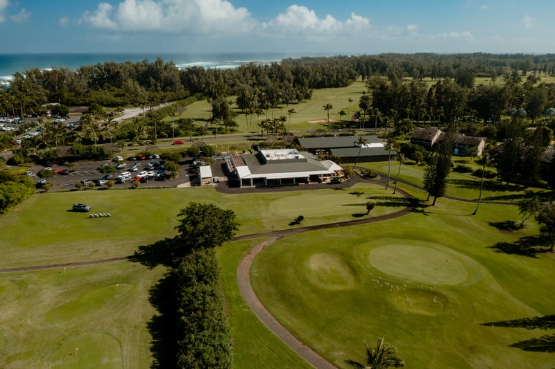 The clubhouse and practice greens at Kuilima Estates offer a convenient launch point for a round of golf, surrounded by wide fairways and ocean breezes.