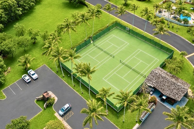 Tennis courts at Kuilima Estates sit beneath swaying palms and island sun, perfect for a friendly match before heading to the beach or pool.