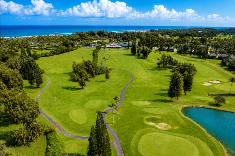 The clubhouse and practice greens at Kuilima Estates offer a convenient launch point for a round of golf, surrounded by wide fairways and ocean breezes.