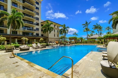 The pool’s calm waters reflect the lush greenery, creating a serene ambiance for every guest. A perfect spot for relaxation or socializing.
