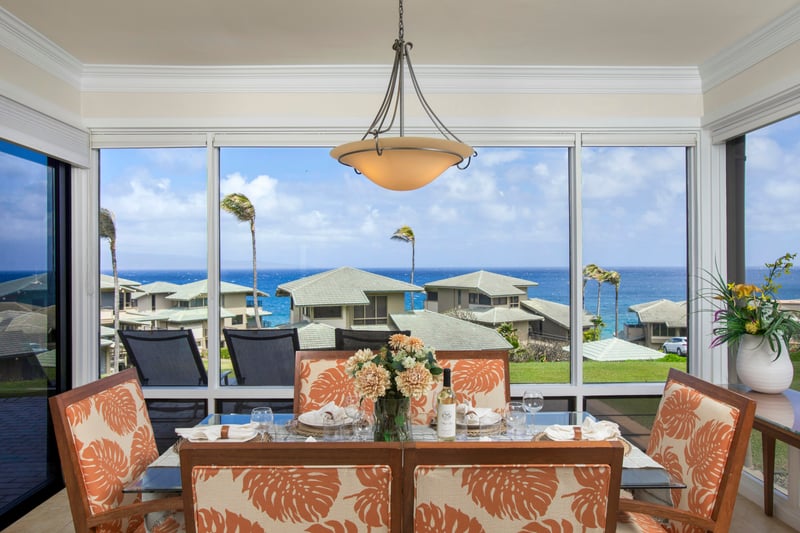 Meals hit differently when you’re seated in bold island prints, with a sea breeze in the background and glass walls framing every bite