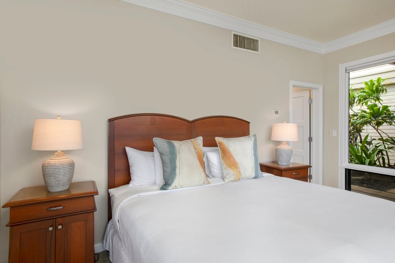 Soft sheets, sunshine, and a peek at paradise—this guestroom is your perfect little island hideaway