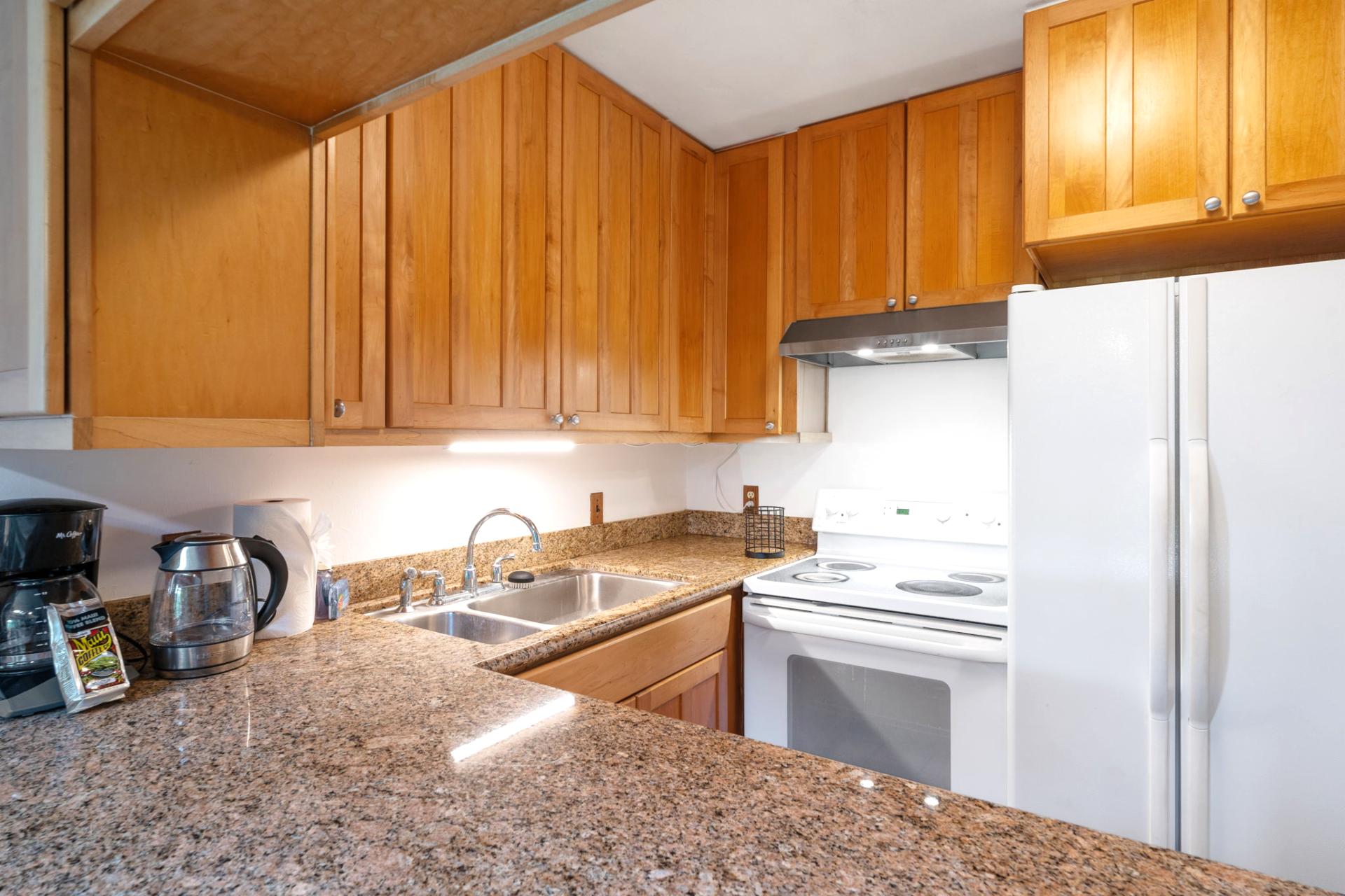 Where golden cabinetry meets granite sparkle—this cozy culinary cove invites you to brew, bake, or just bask    