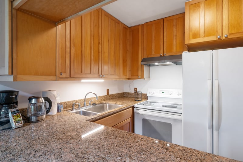 Where golden cabinetry meets granite sparkle—this cozy culinary cove invites you to brew, bake, or just bask KUL-E113