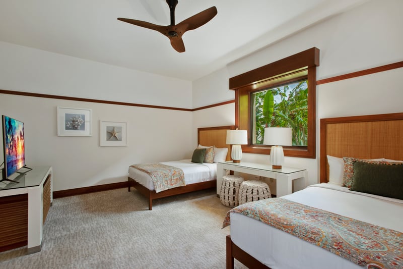 A second guest bedroom includes multiple beds, warm wood accents, and garden views through wide windows. MON-2204