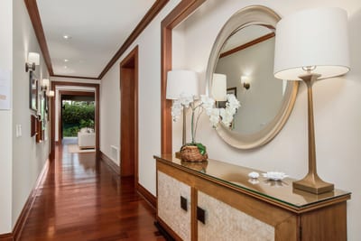 Step into serenity—this charming entryway sets the tone with soft lighting, fresh blooms, and a welcoming glow MON-2204