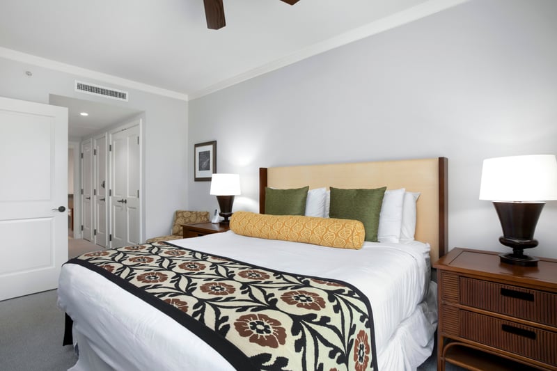 Cozy island bedroom featuring botanical accents and warm wood finishes. HKK-220
