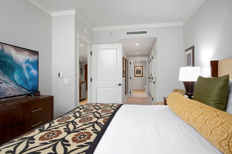 Inviting bedroom escape with cozy touches and ensuite hallway access. HKK-220