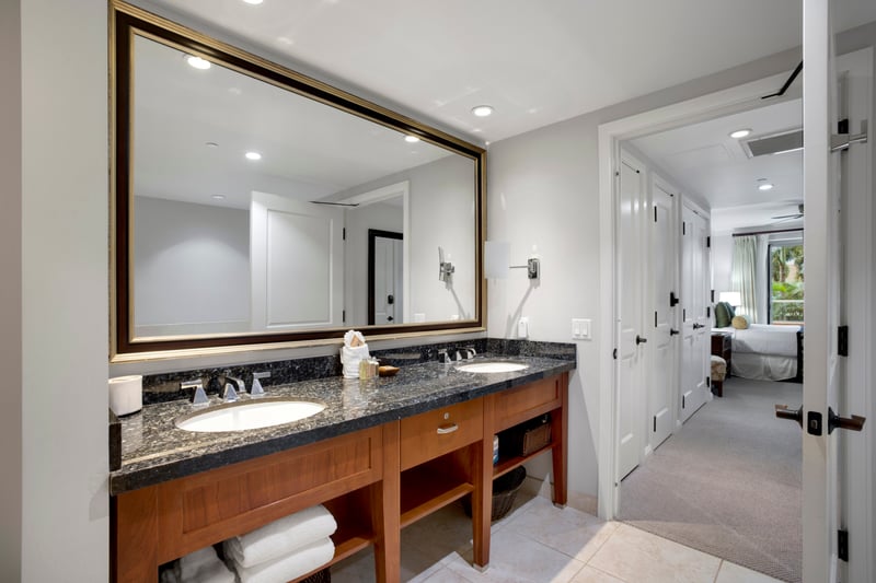 His-and-hers sinks set in a granite vanity add a touch of modern elegance. HKK-220