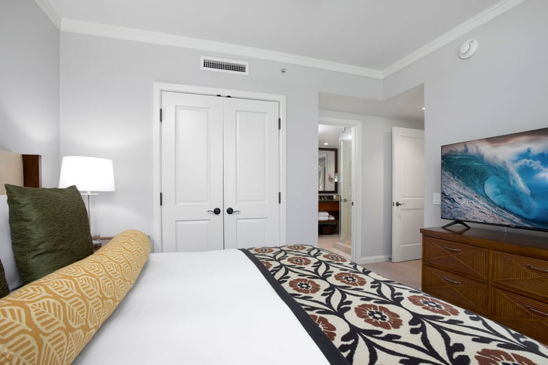 Comfortable bedroom with ensuite bath, tropical tones, and cozy ambiance. HKK-220
