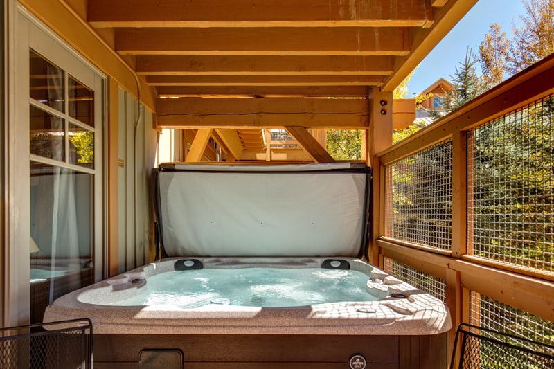 Soak in your private outdoor hot tub surrounded by forest views and fresh alpine air, just steps from the living area.