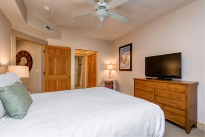 Guest Bedroom 1 includes a Queen bed, Smart TV, and private ensuite bath. Ideal for couples or additional family members. TPC-102C