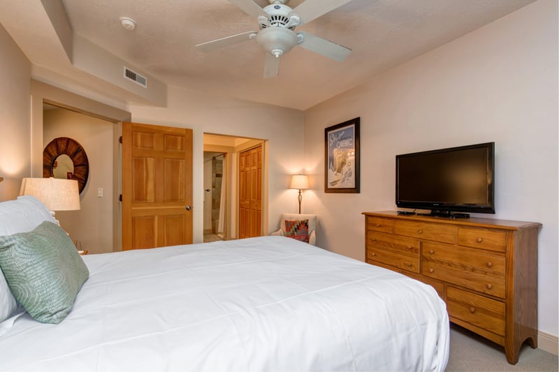 Guest Bedroom 1 includes a Queen bed, Smart TV, and private ensuite bath. Ideal for couples or additional family members.