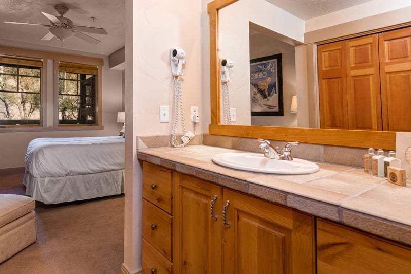 Your guest ensuite includes a rustic vanity with granite counter, natural light, and thoughtful amenities.