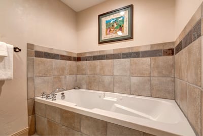 Unwind in your deep soaking tub with tiled surround. Perfect for après-ski relaxation or a quiet evening in. TPC-102C