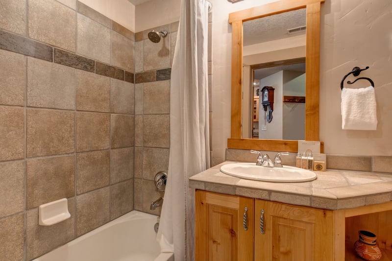 Your third full bath includes a tiled shower, granite vanity, and warm wood finishes for a clean, cozy refresh.