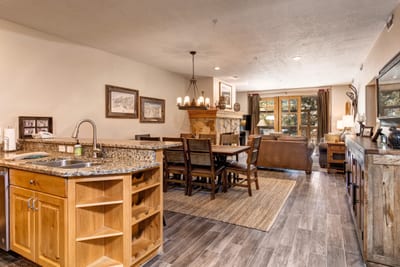 Gather for meals or board games in this open-concept dining space with natural light and views into the cozy living area. TPC-102C