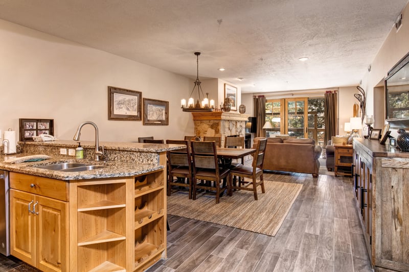 Gather for meals or board games in this open-concept dining space with natural light and views into the cozy living area.
