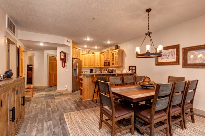 Dine together at the wooden table for eight, perfectly placed between the kitchen and living area for effortless flow and connection.