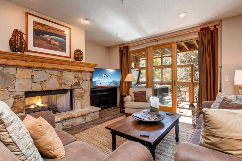 Enjoy the open-concept living area with ample seating, a Smart TV, and access to the balcony for indoor-outdoor relaxation. TPC-102C