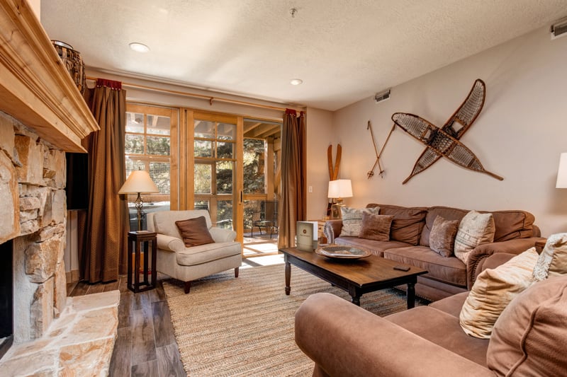 Cozy up in your mountain retreat with vintage mountain décor, plush seating, and direct access to the balcony and fresh alpine air.