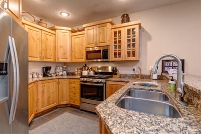 Your fully equipped kitchen features granite counters, appliances, and bar seating for easy snacks or casual meals. TPC-102C