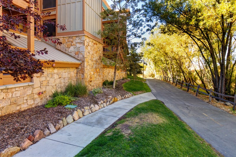 A scenic path lined with aspens and stone walls leads you through peaceful surroundings just outside your door.