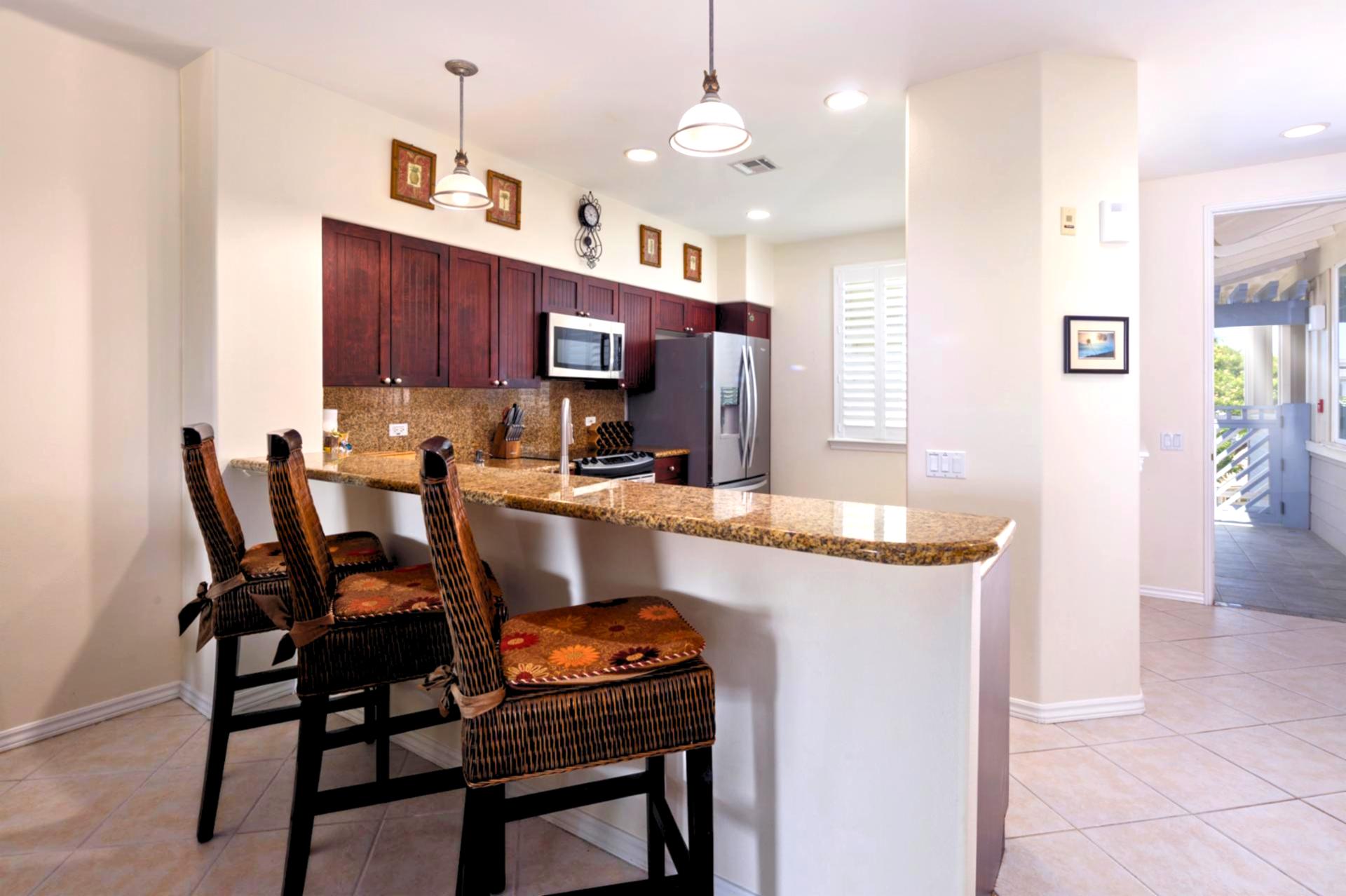 Your kitchen island offers plenty of prep space and seating for quick bites before heading out.