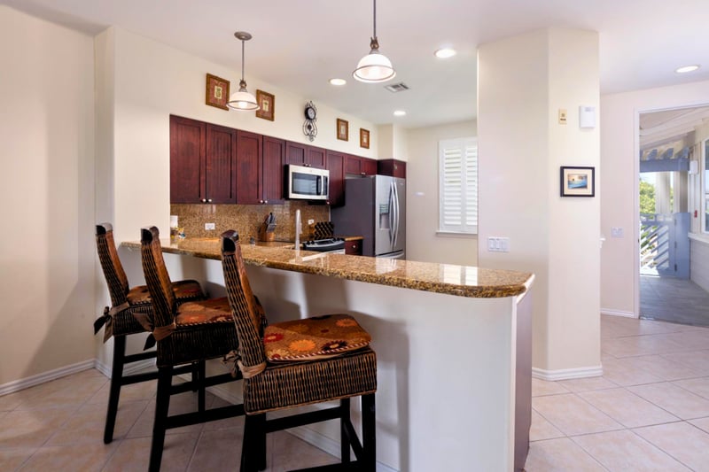 Your kitchen island offers plenty of prep space and seating for quick bites before heading out.