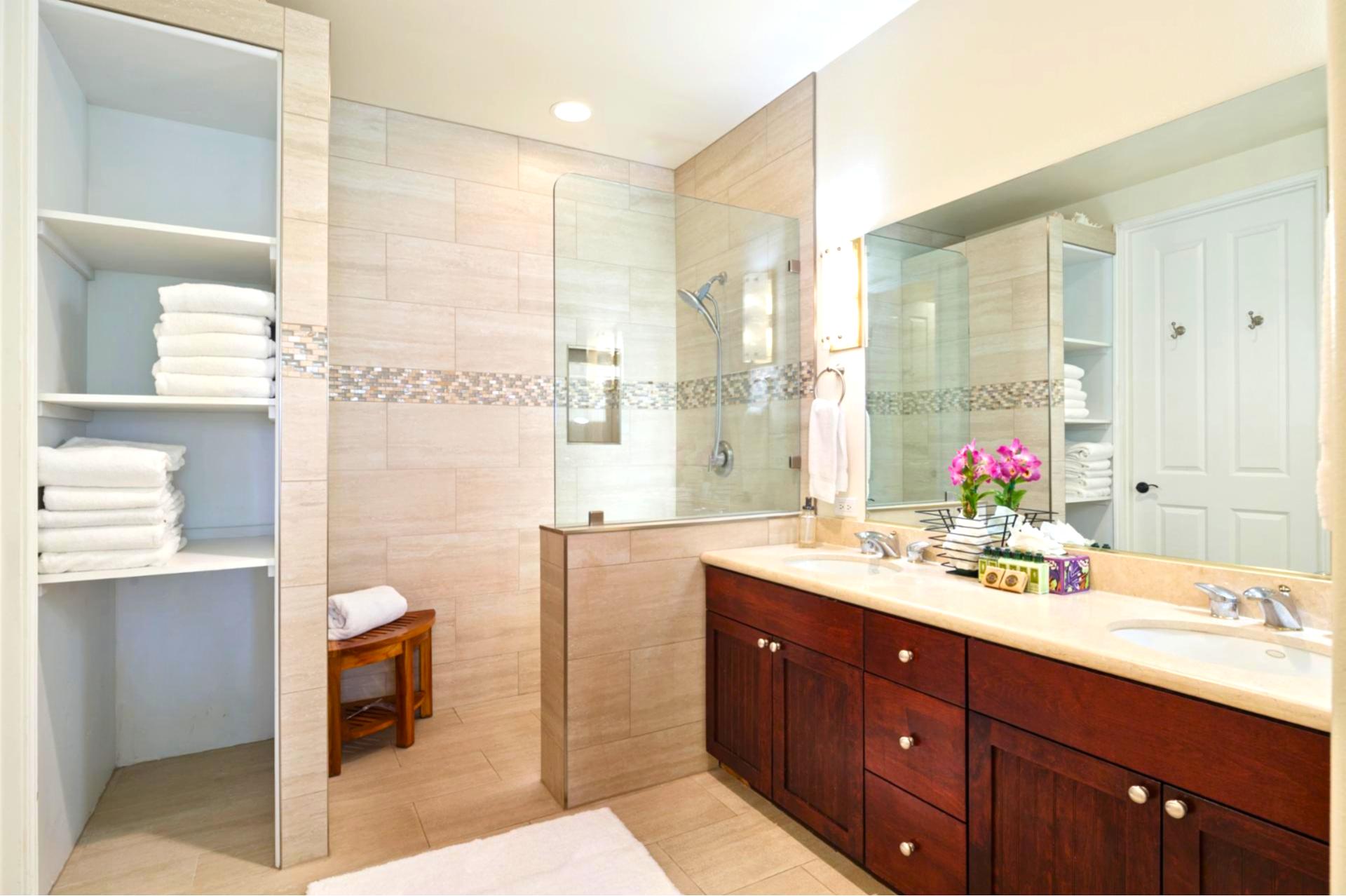 Primary bath features a dual granite vanity and walk-in shower for a spa-like refresh.