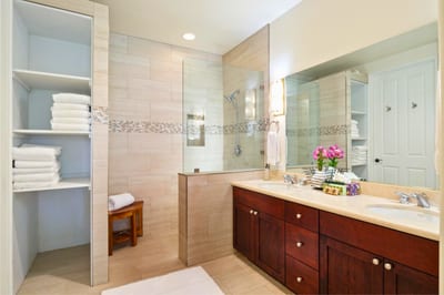 Primary bath features a dual granite vanity and walk-in shower for a spa-like refresh.