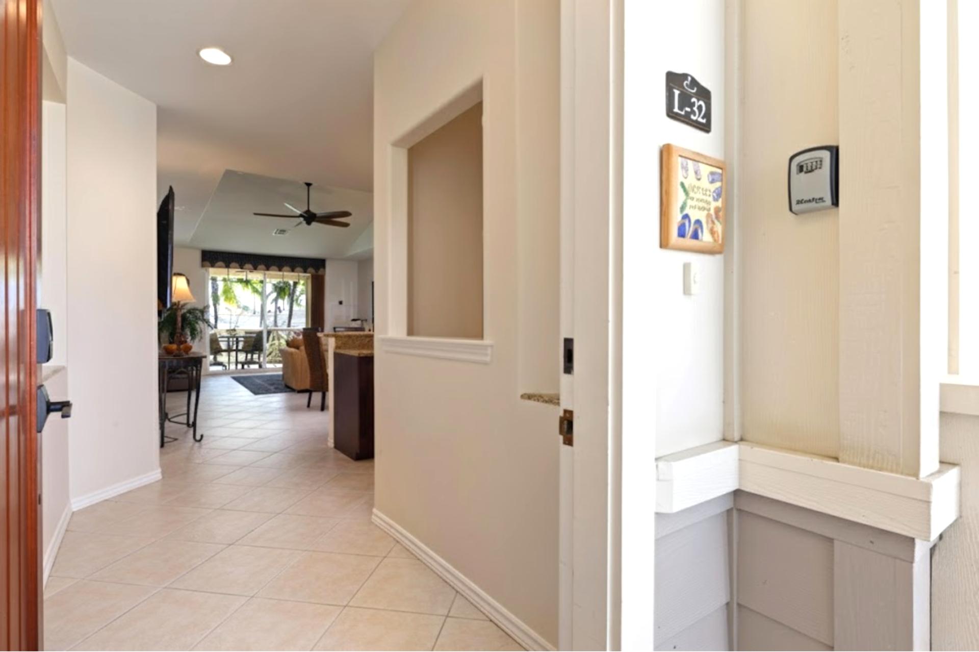 Entry hallway connects the bedrooms and main living space with warm lighting and tile floors.