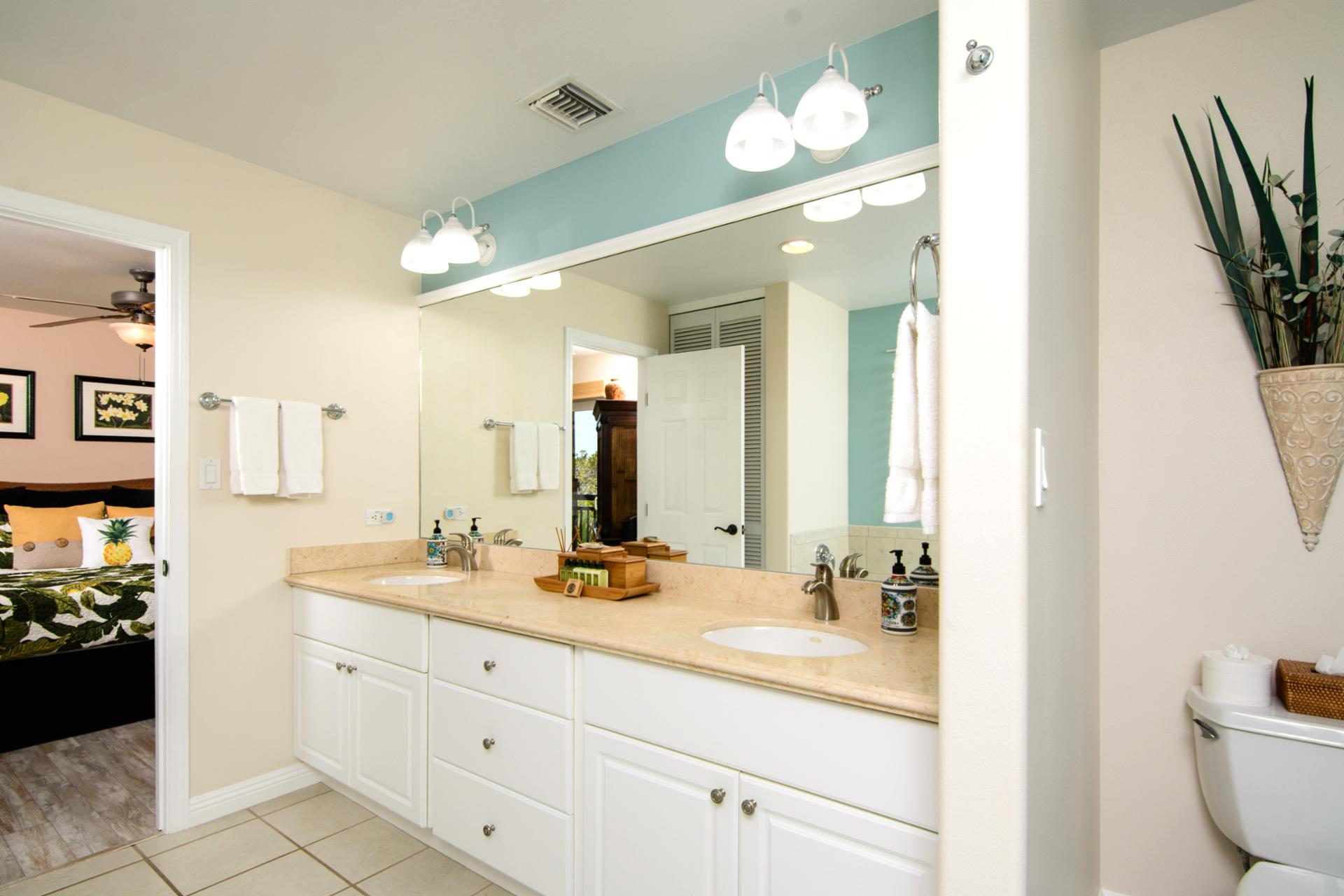 Double vanity bathroom with spacious layout and warm finishes