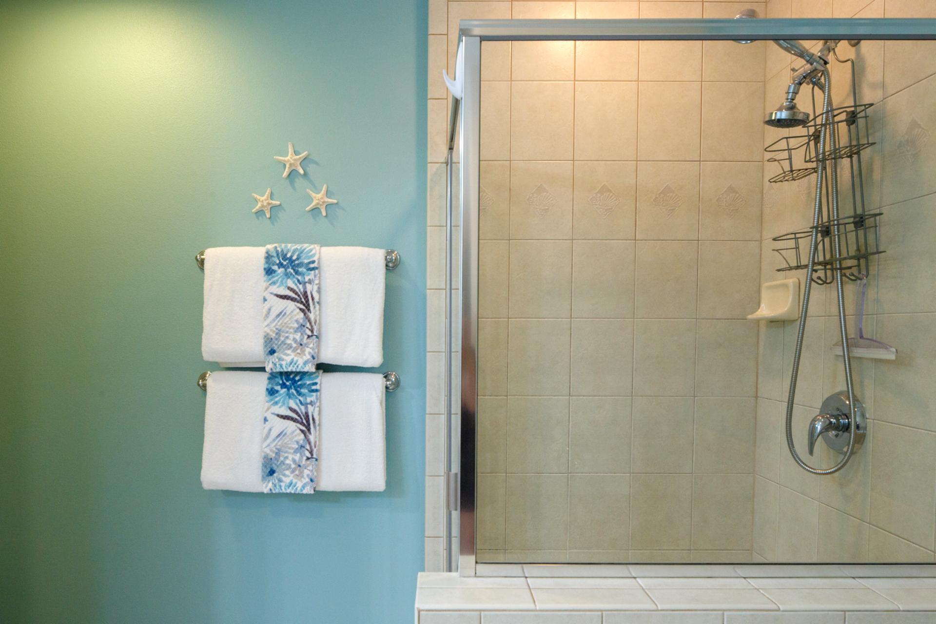 Clean tiled shower and tub with tropical colors and fresh design