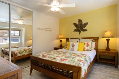 Cozy guest bedroom with floral bedding and serene garden views