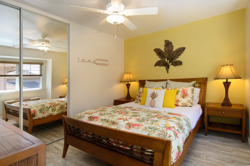 Cozy guest bedroom with floral bedding and serene garden views WCV-305