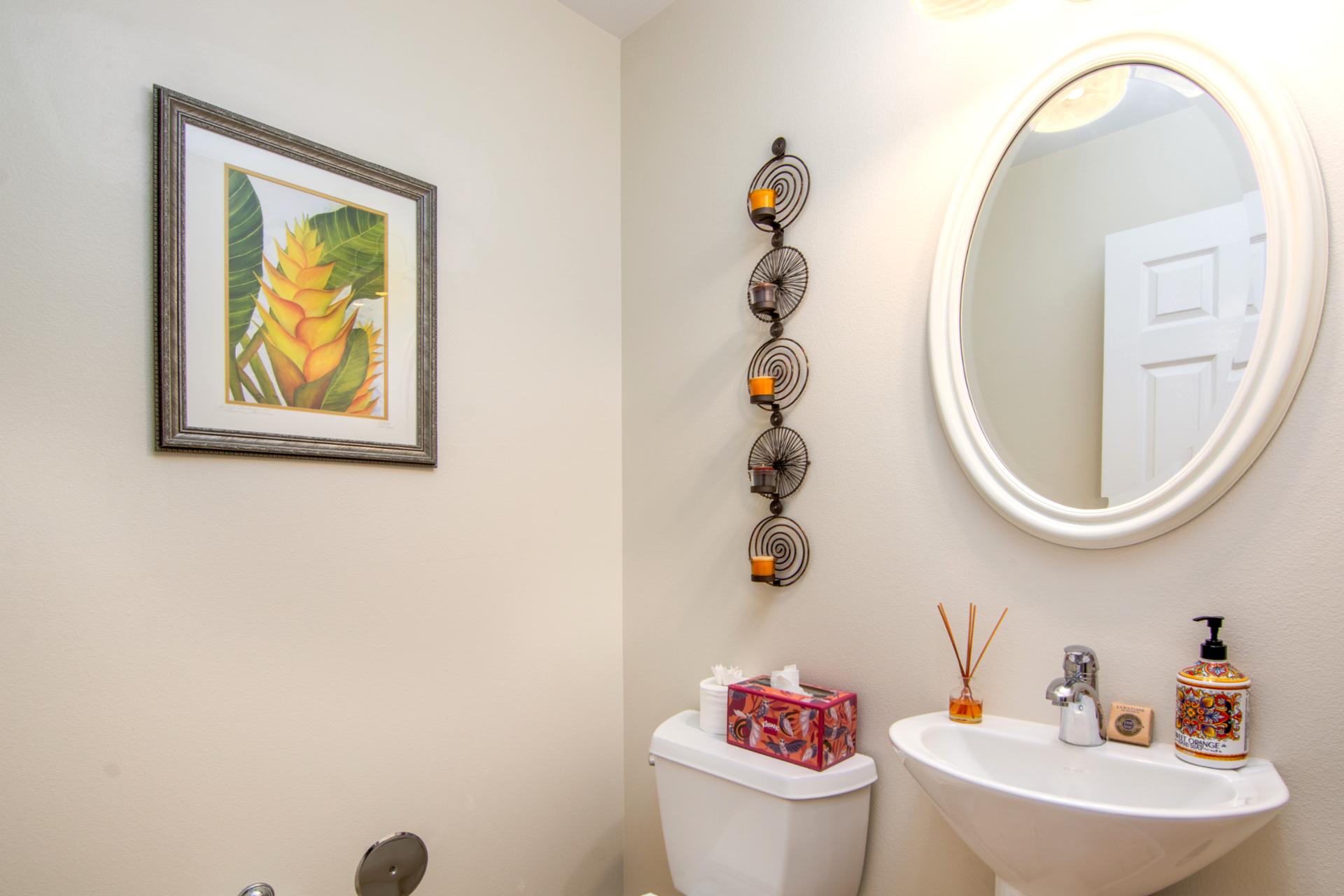 Charming half bath with round mirror and modern fixtures