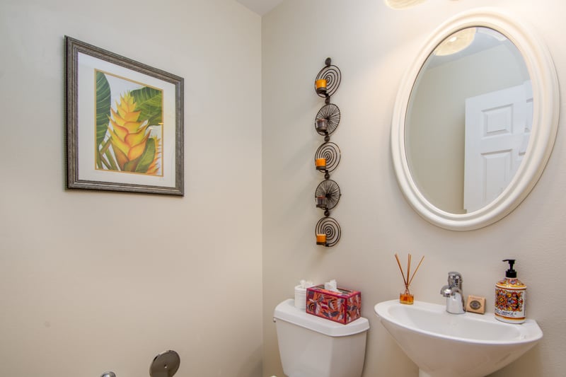 Charming half bath with round mirror and modern fixtures