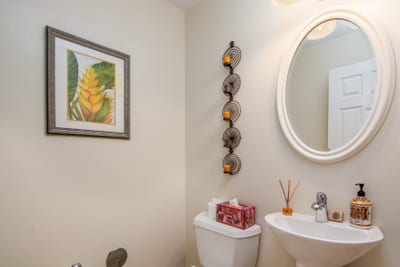 Charming half bath with round mirror and modern fixtures