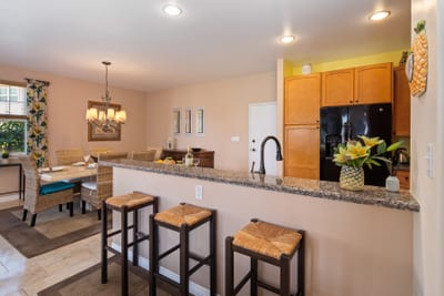 Modern kitchen with granite counters and bar seating for casual bites