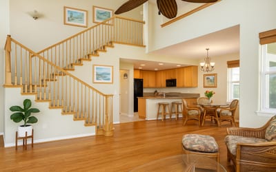 Beautiful hardwood floors and staircase elevate the warmth of this island getaway