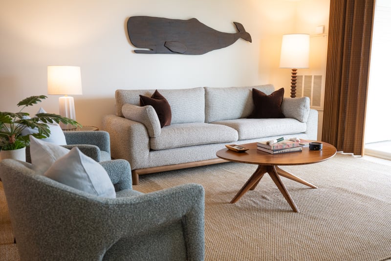 The living room offers comfortable seating and easy access to the lanai through large sliding glass doors FVW-L21