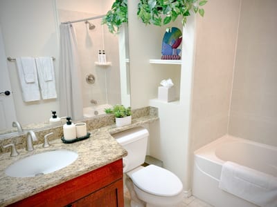 The guest bathroom features bright finishes and ample space to prepare for the day ahead