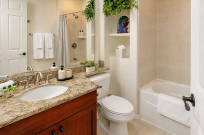 The guest bathroom features bright finishes and ample space to prepare for the day ahead